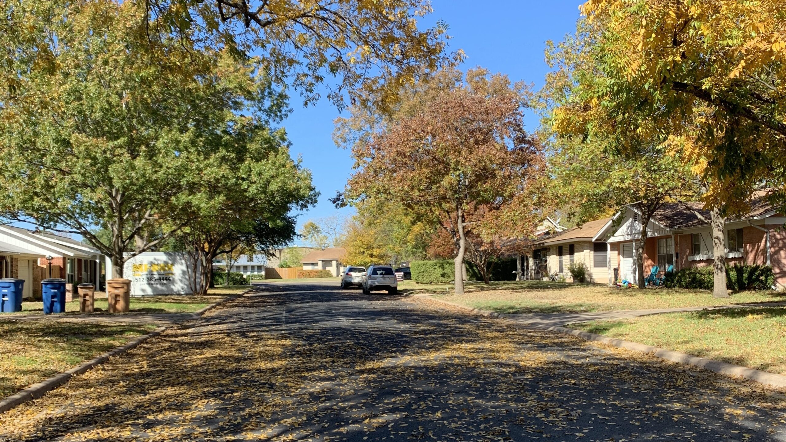 Established homes along a tree-lined street in the Brentwood neighborhood of Austin, Texas.