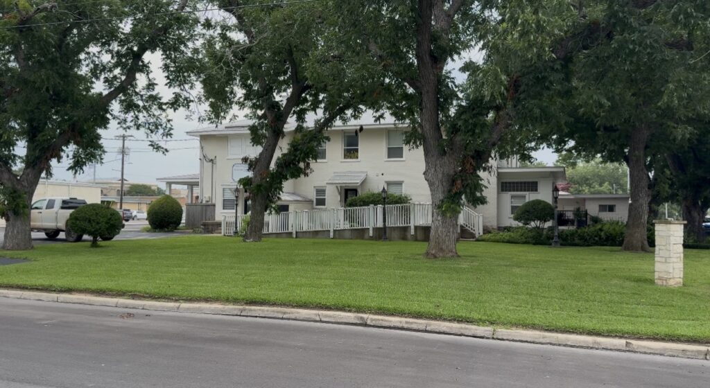 Mature trees and historic residential character in Bastrop, Texas.